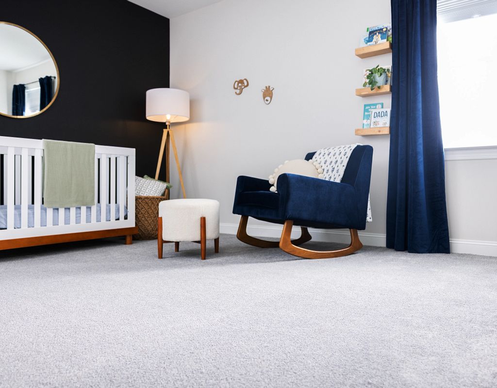 Carpet flooring with blue couch | Bram Flooring